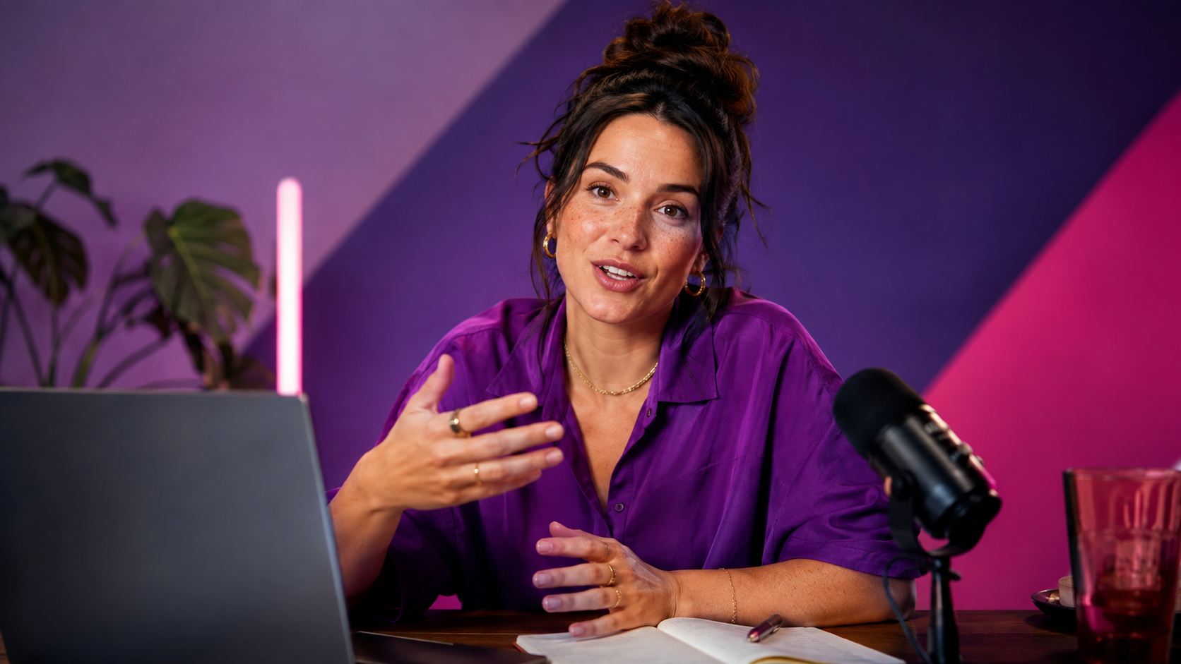 A coach talking with a client from her desk during a short video call.